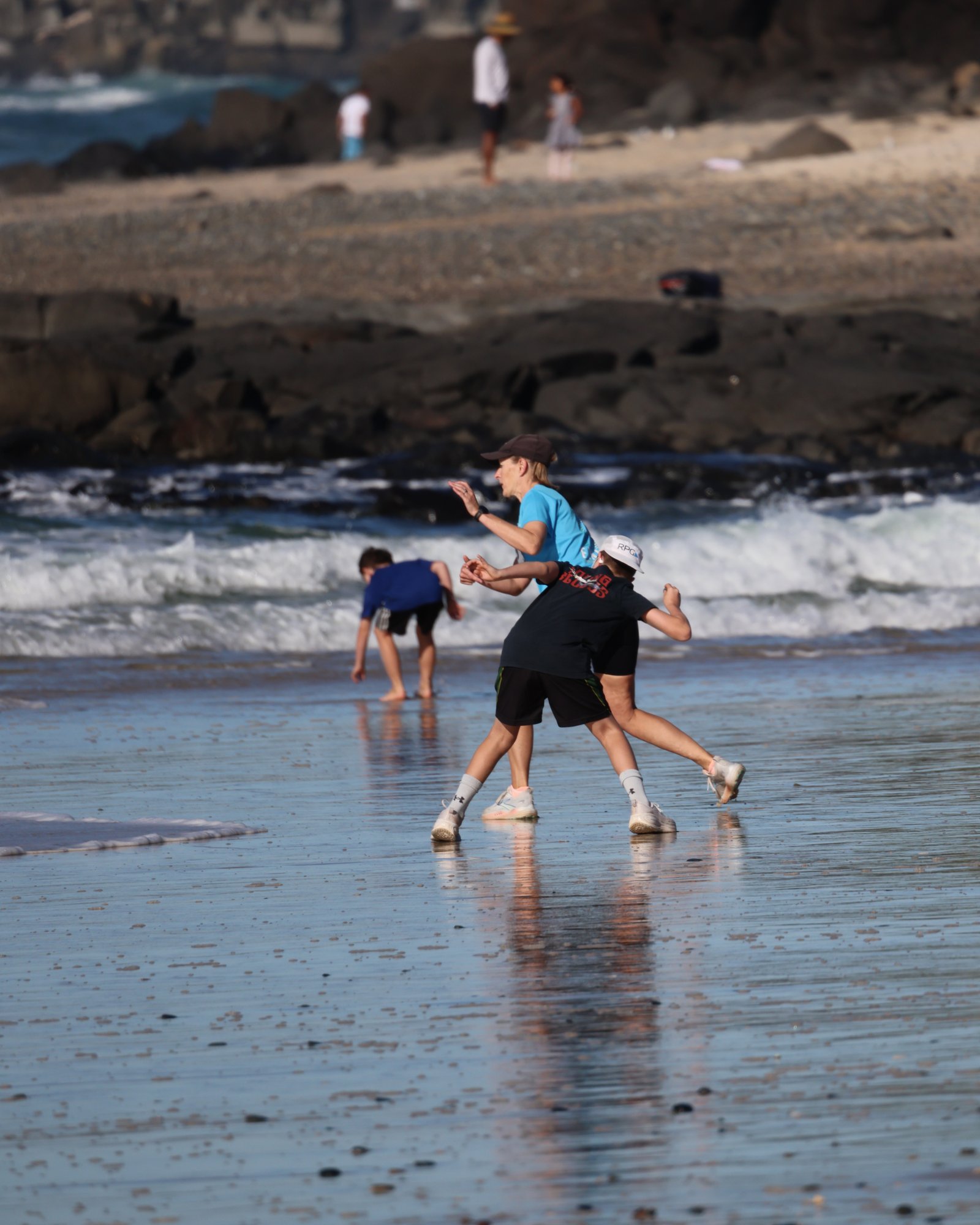 A young runner crossing the finish line at Shelly Beach